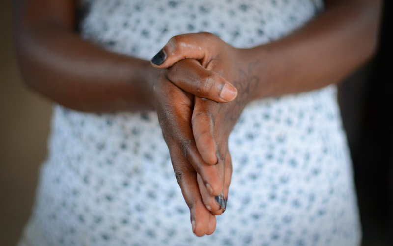 a black woman's hands clasped together